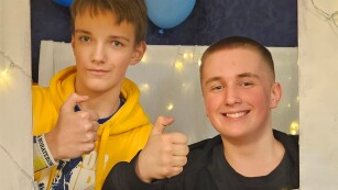 Dwóch chłopców trzymających kciuki w ramce okolicznościowej z napisem karnawał 2024